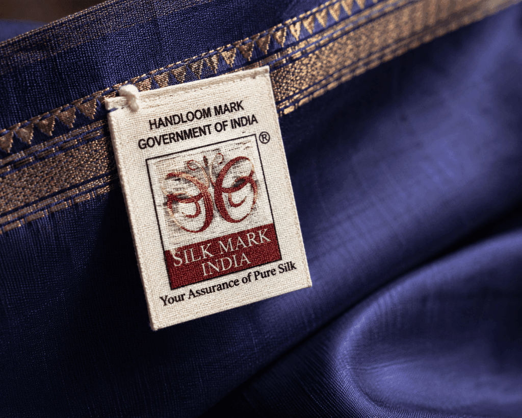 India Handloom Silk Mark government certification label attached to saree border confirming authentic handloom weaving