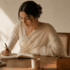 Woman wearing a pale ivory Chanderi cotton-silk saree at an office desk