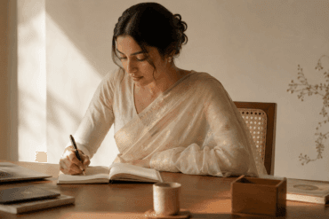 Woman wearing a pale ivory Chanderi cotton-silk saree at an office desk