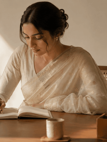 Woman wearing a pale ivory Chanderi cotton-silk saree at an office desk