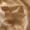 Pale gold Chanderi silk-cotton saree with zari border and floral butti motifs on white marble