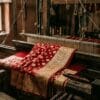 Bridal red Banarasi katan silk saree with gold zari on a wooden pit loom in Varanasi