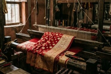 Bridal red Banarasi katan silk saree with gold zari on a wooden pit loom in Varanasi