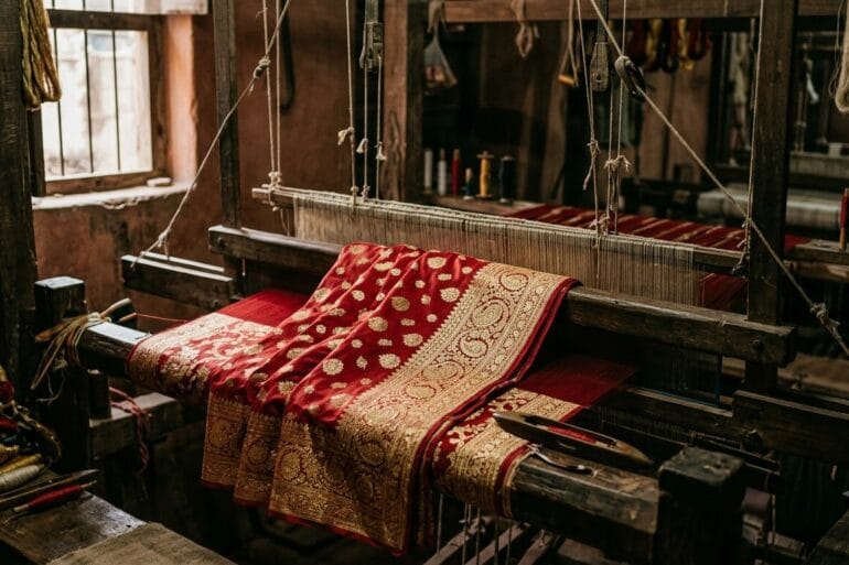 Bridal red Banarasi katan silk saree with gold zari on a wooden pit loom in Varanasi