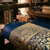 Real zari thread on a Banarasi saree border, tested against Varanasi loom light