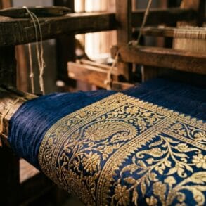 Real zari thread on a Banarasi saree border, tested against Varanasi loom light