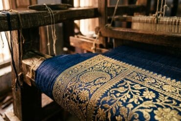 Real zari thread on a Banarasi saree border, tested against Varanasi loom light