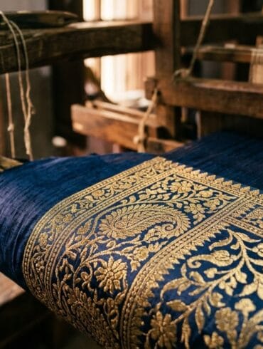 Real zari thread on a Banarasi saree border, tested against Varanasi loom light