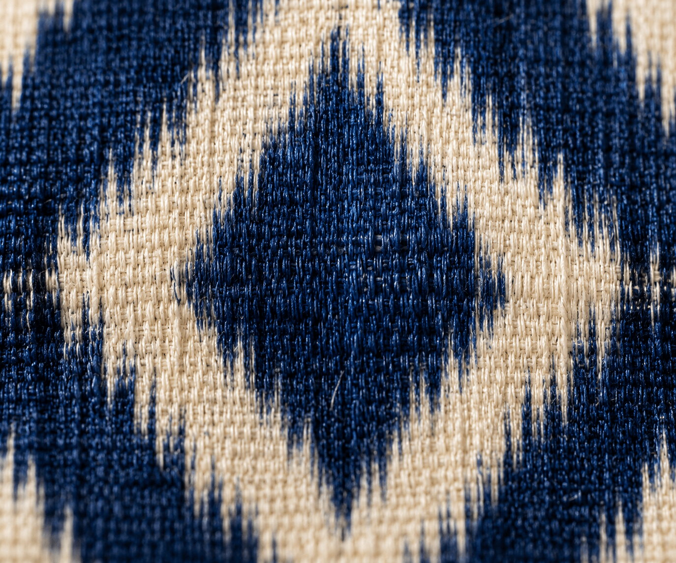 Macro of Pochampally ikat cloth showing the feathered soft edge of a dyed diamond motif
